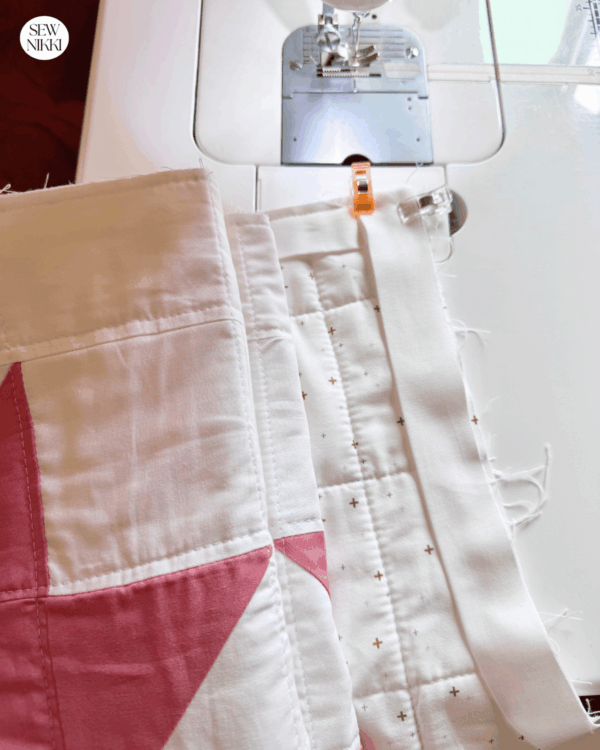 I machine bind one side of the quilt at a time, cut thread and then reroll and start fresh on the next side by Sew Nikki
