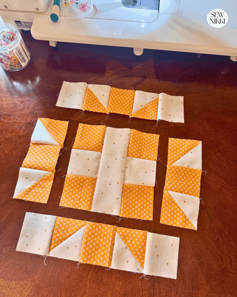Sewing sections of the quilt block together, pressing seams as you go by Sew Nikki