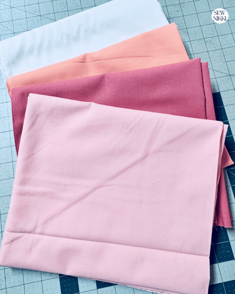Solid fabrics over prints will make your quilt look more modern by Sew Nikki