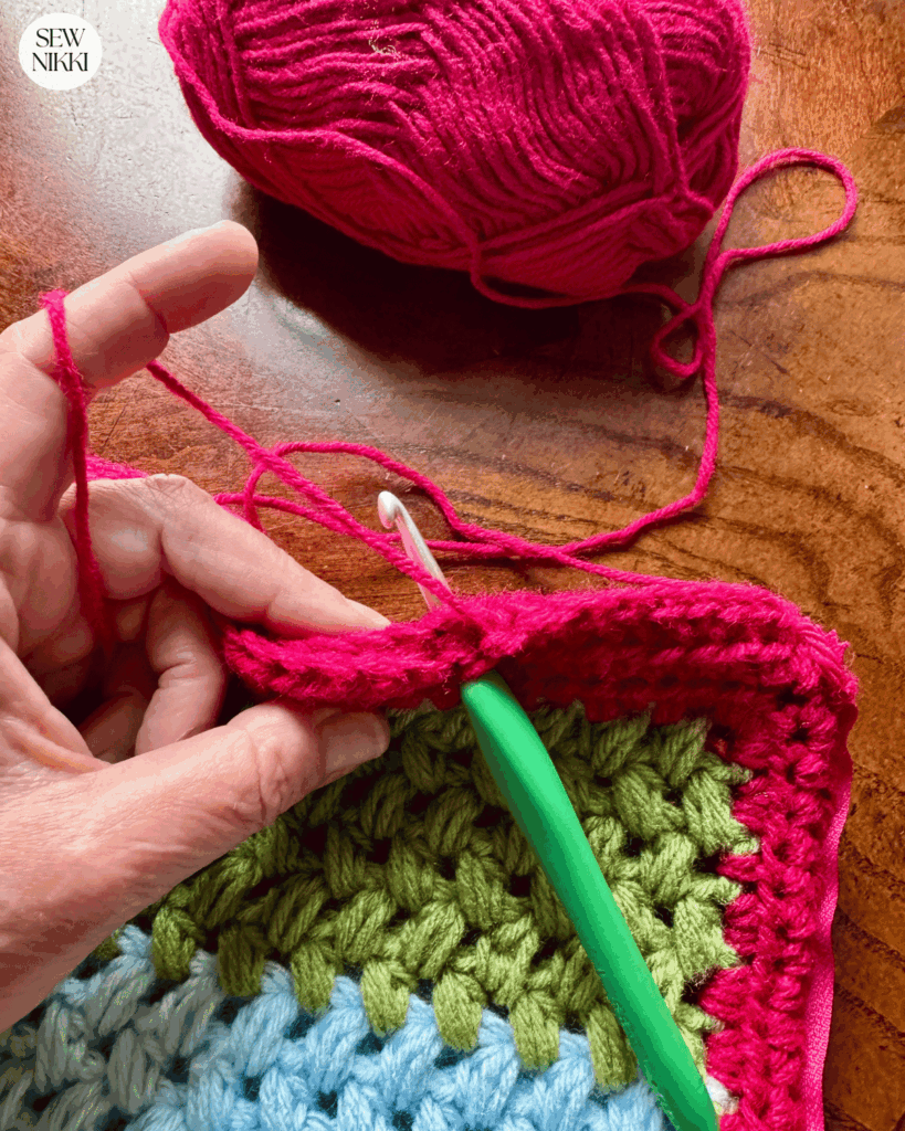 Closing the crochet pillow cover panels with a single crochet stitch by Sew Nikki