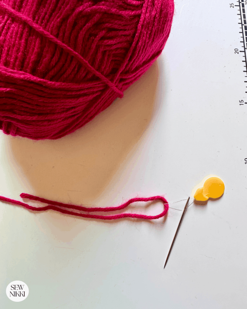 I like to use thread needles, a needle threader and yarn to attach zippers to crochet items by Sew Nikki