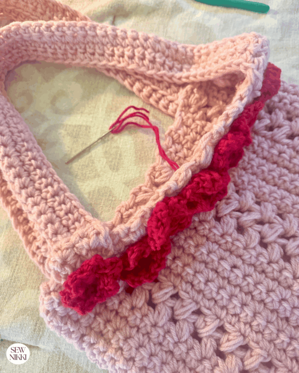 Use the yarn tails to connect flowers to bag using a yarn needle by Sew Nikki