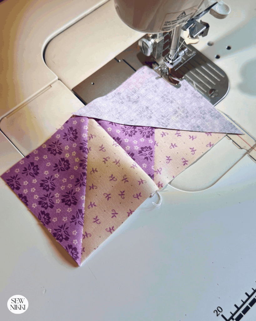 Sewing the first row together to make a Birds in the Air quilt block by Sew Nikki