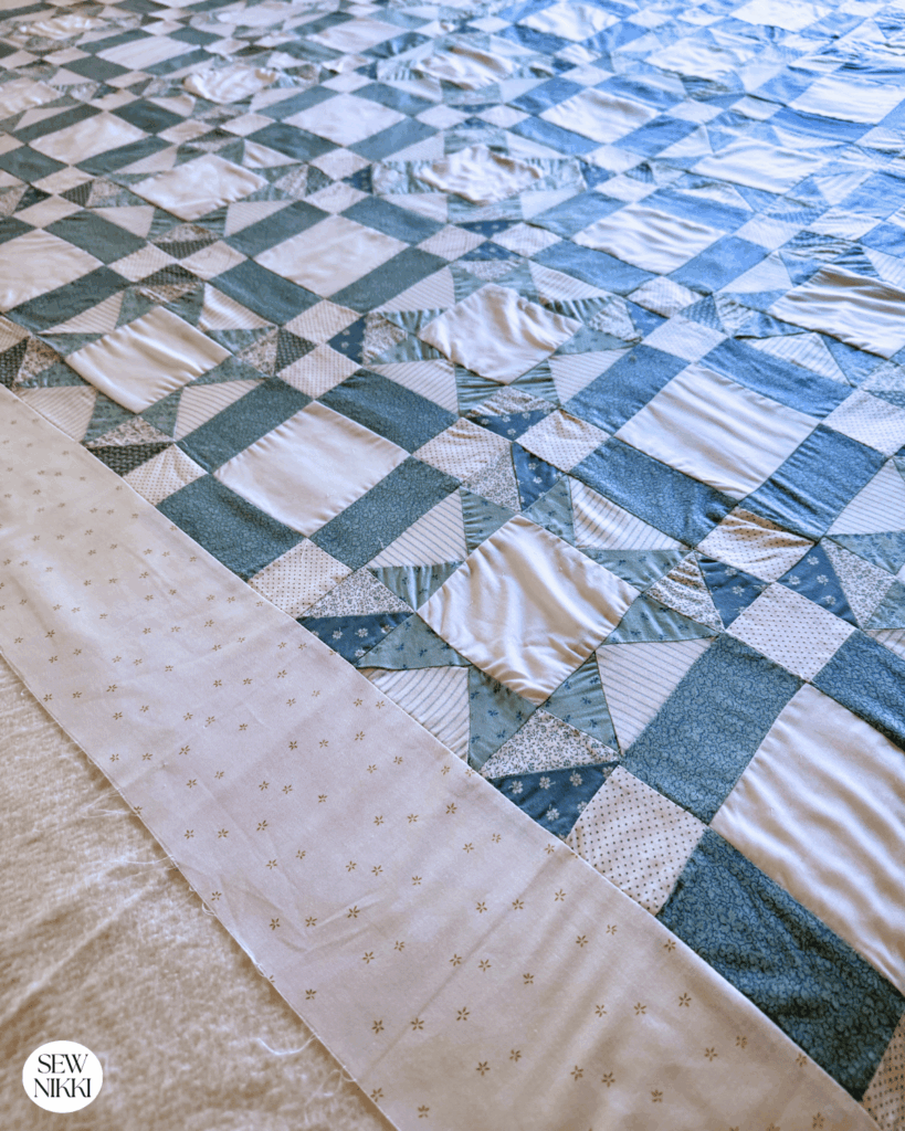 Here's the basted quilt showing the surface I had to quilt while avoiding the problem areas by Sew Nikki