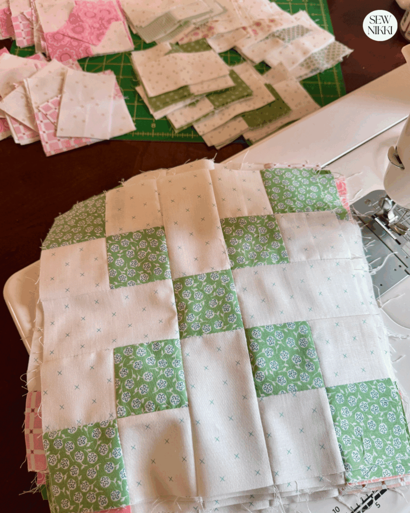 Pile of quilt blocks and units waiting to be sewn into blocks by Sew Nikki