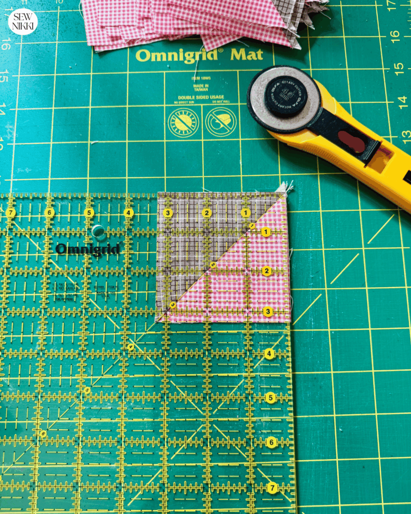 Square up all 8 half square triangles using a square quilting ruler and rotary cutter by Sew Nikki