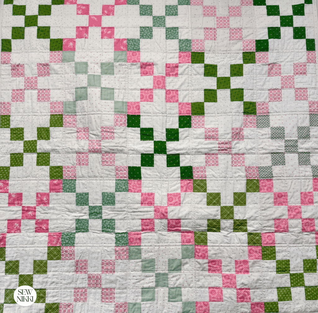 Single Irish Chain Variation Quilt Pattern by Sew Nikki - baby size version of this pattern with scrappy fabrics in green and pink.