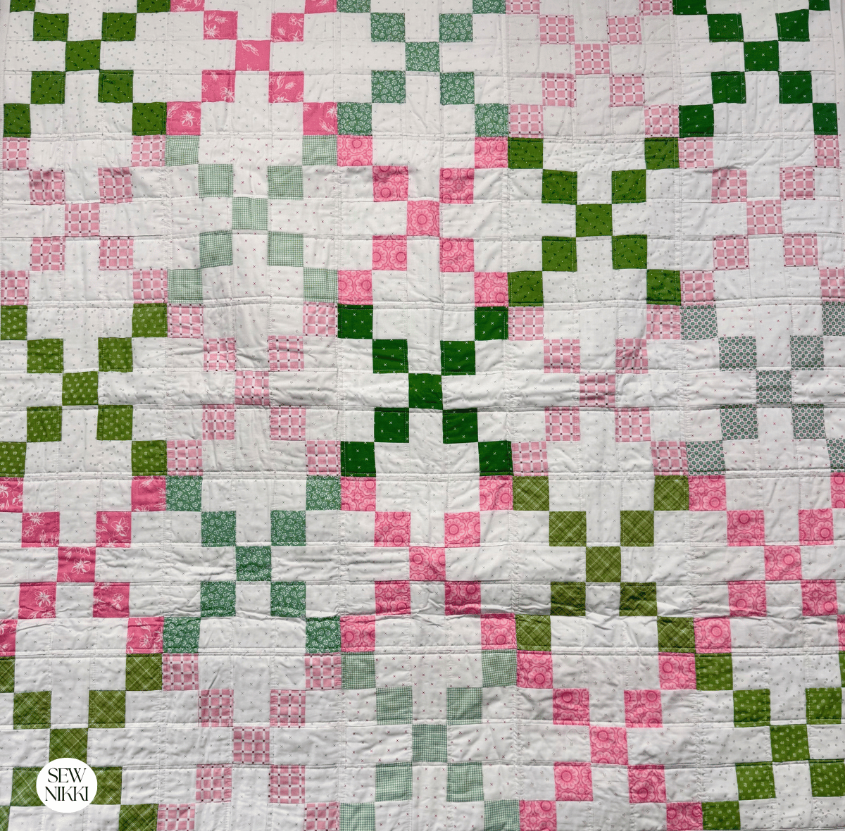 Single Irish Chain Variation Quilt Pattern by Sew Nikki - baby size version of this pattern with scrappy fabrics in green and pink.