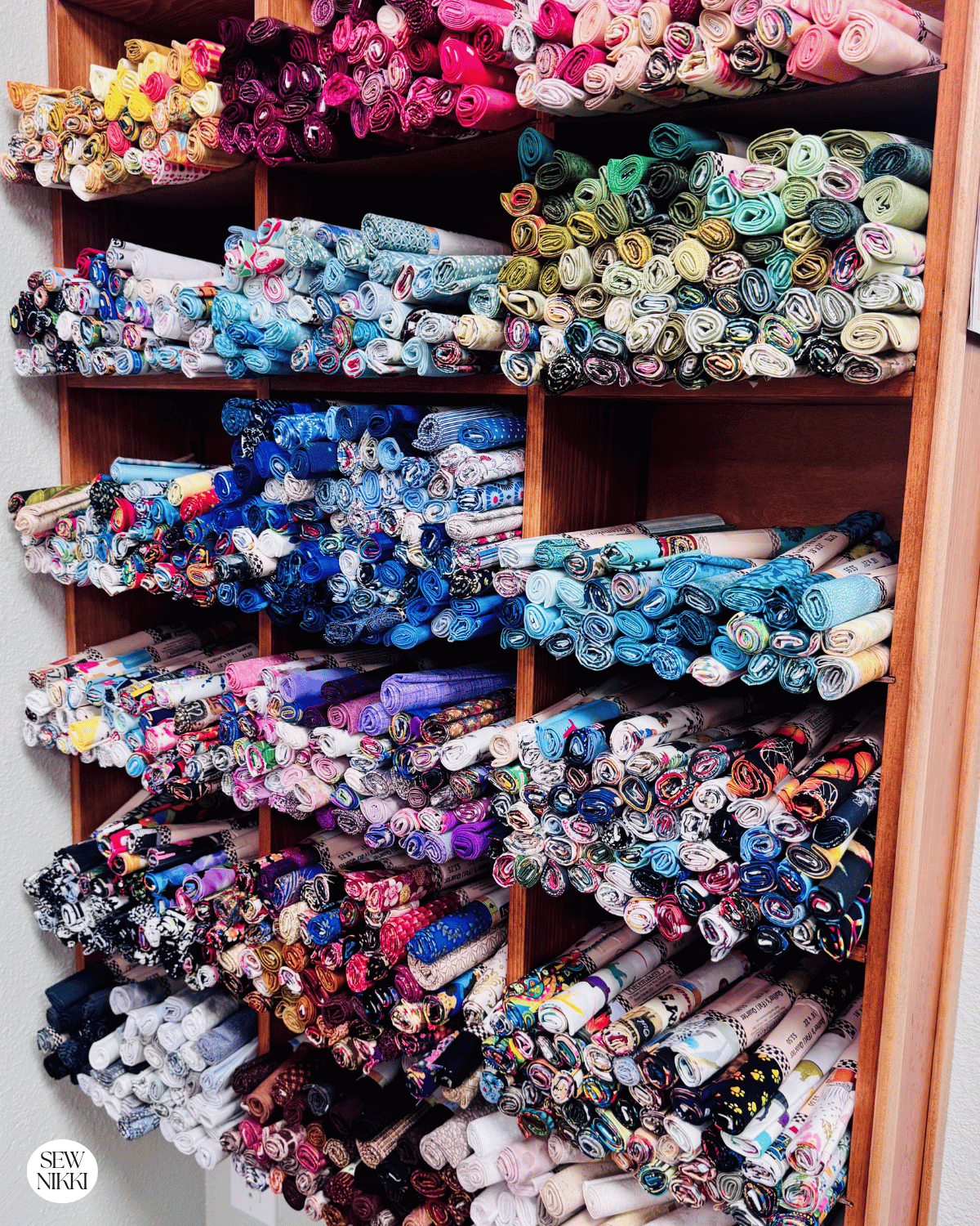 Wall of assorted fat quarters sold individually at a local quilt shop by Sew Nikki