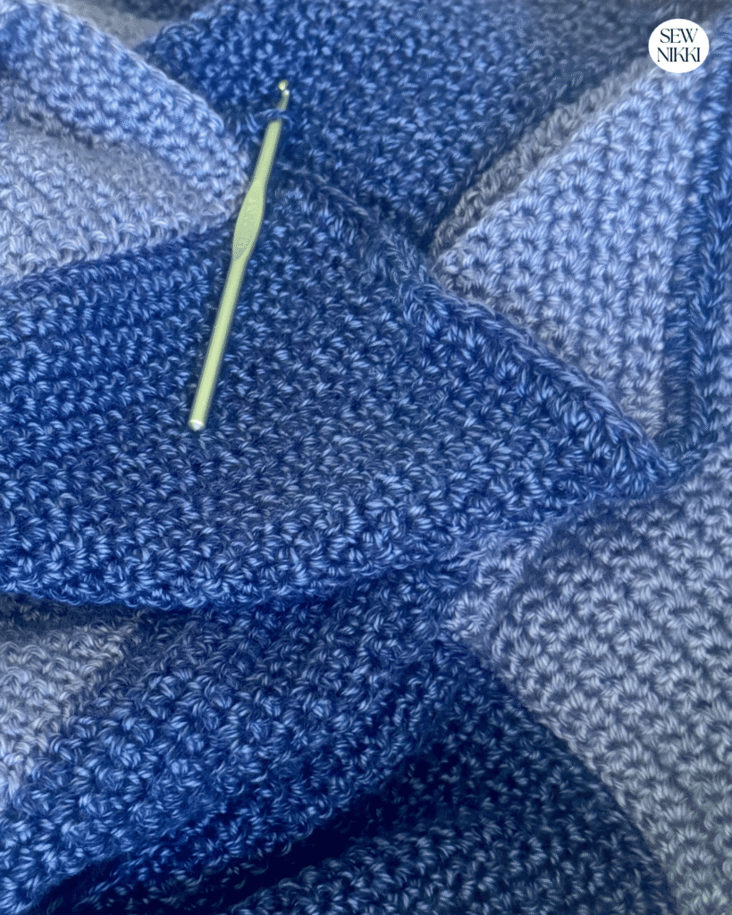 Add a simple half double crochet border one time around the entire crochet blanket to finish by Sew Nikki